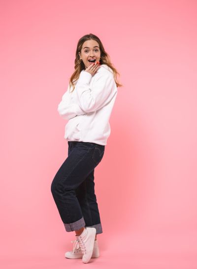 Full length image of Surprised happy blonde woman