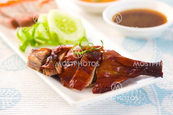 chinese roast duck drumstick served with chili and cucumbers