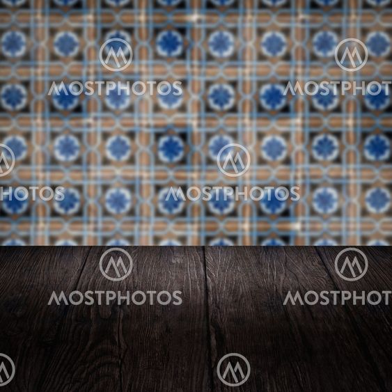 Wood table top and blur vintage ceramic tile pattern wall