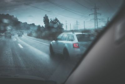 Cars on a highway at a rainy dusk (shallow DOF; color...