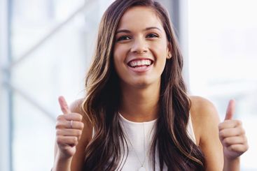 Office, businesswoman and smile with hands for thumbs...