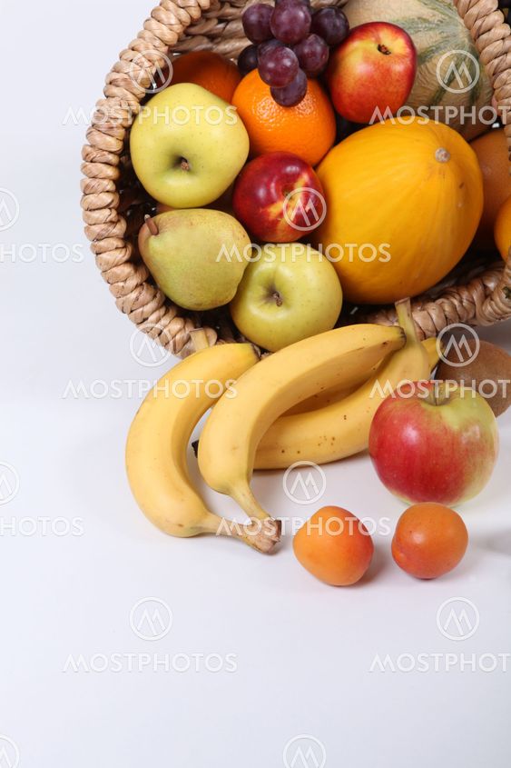 Wicker basket overflowing with fresh shiny fruit