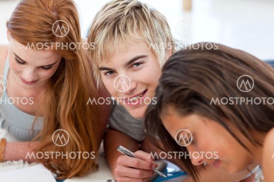 Portrait of a teen guy doing homework