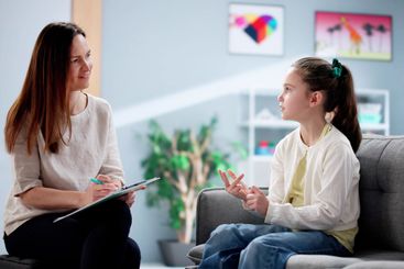 Caring therapist helps unhappy child overcome sadness...