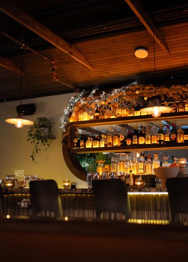 backdrop of moody bar at fine dining restaurant in high...