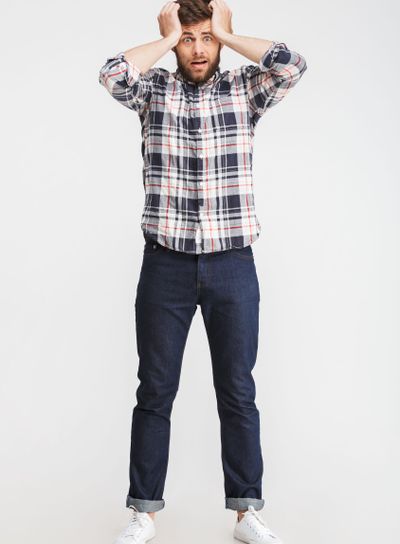 Full length portrait of a shocked young man