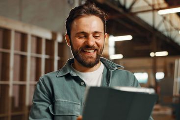 Smile, man and carpenter with tablet in workshop for...
