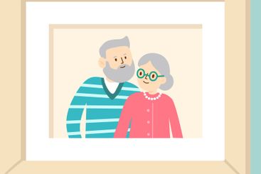 Happy elderly couple smiling together in a simple wooden...