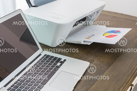 printer and Laptop on wood table