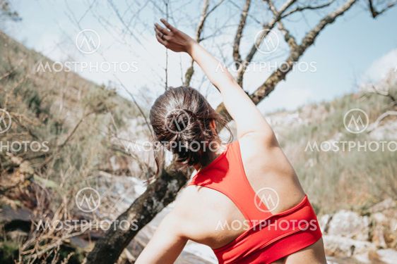 Young woman exercising in sport clothes in front of a...