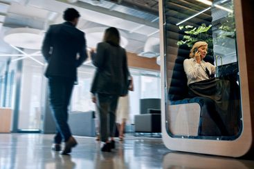 Lobby, talking and business people with cubicle in...