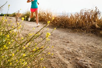 Young woman on her evening jog along the seacoast (motion...