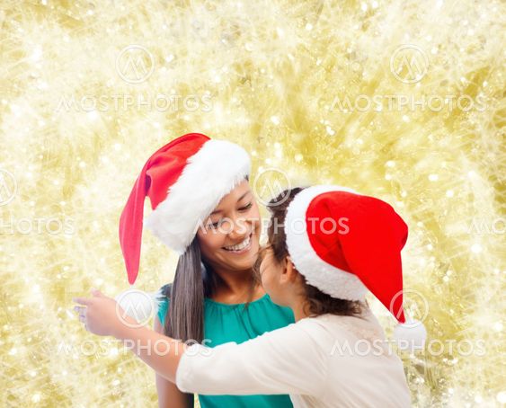 happy mother and girl in santa hats