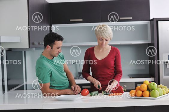 young couple have fun in modern kitchen