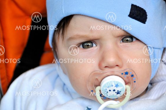 Serious looking baby with dummy