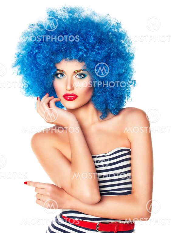 Portrait of a young beautiful girl with bright makeup in blue wig