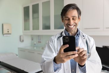 Cheerful male Hispanic doctor man chatting with patients