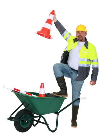 Traffic worker with cone and wheelbarrow