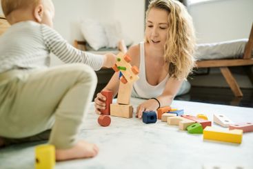 Mother, child and playing with baby toys or learning...