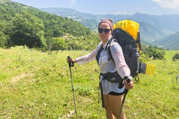 Hiking tourism adventure. Backpacker hiker woman looking...