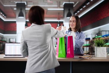 Woman At Hotel Talking To Receptionist