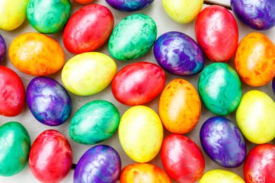 Easter eggs on wooden background. Colorful eggs in...
