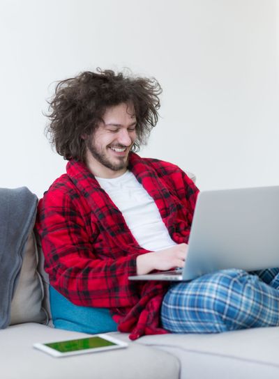 man freelancer in bathrobe working from home