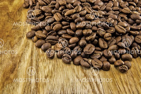 Coffee beans on vintage wooden board
