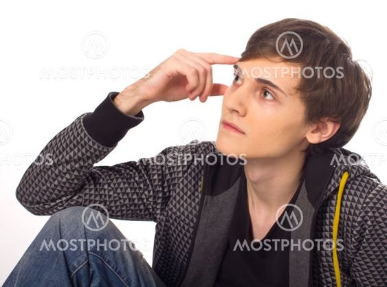 Handsome young man sitting and thinking