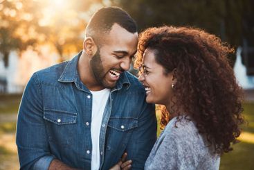 Happy, love and black couple in park laugh together for...