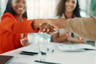 Handshake, teamwork and closeup with business women for...