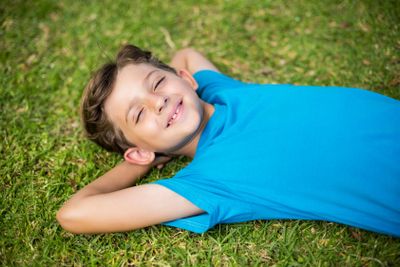 Young boy sleeping in park