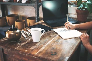 Pottery, notebook and hands with writing in workshop for...