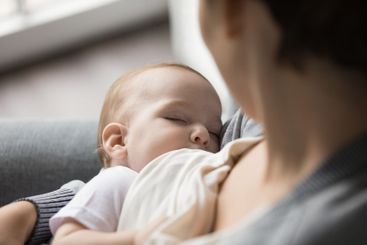 Closeup portrait cute little infant sleep in caring mom...