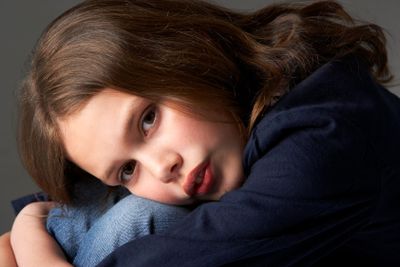 Thoughtful Girl Sitting In Studio