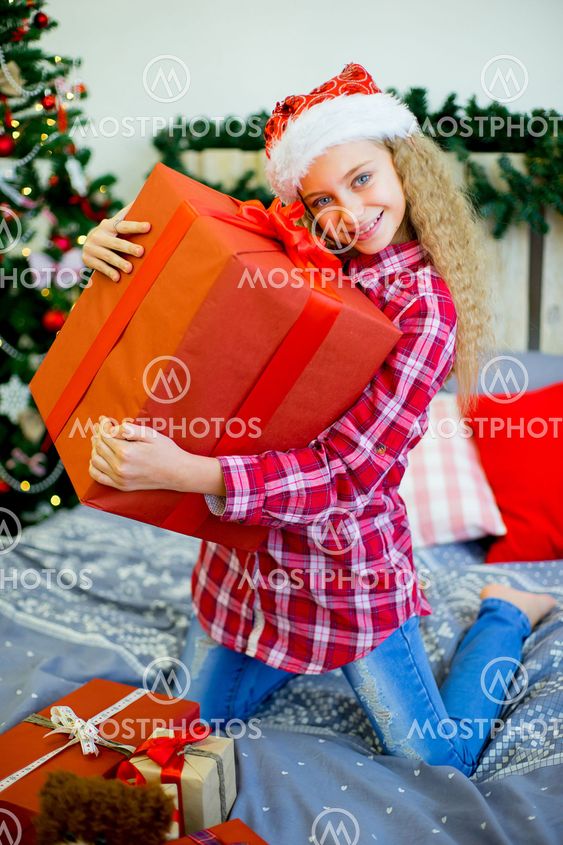 happy child girl with Christmas gifts