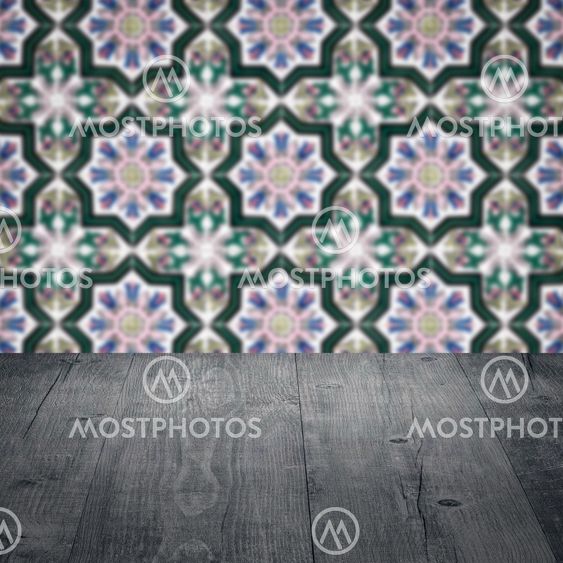 Wood table top and blur vintage ceramic tile pattern wall