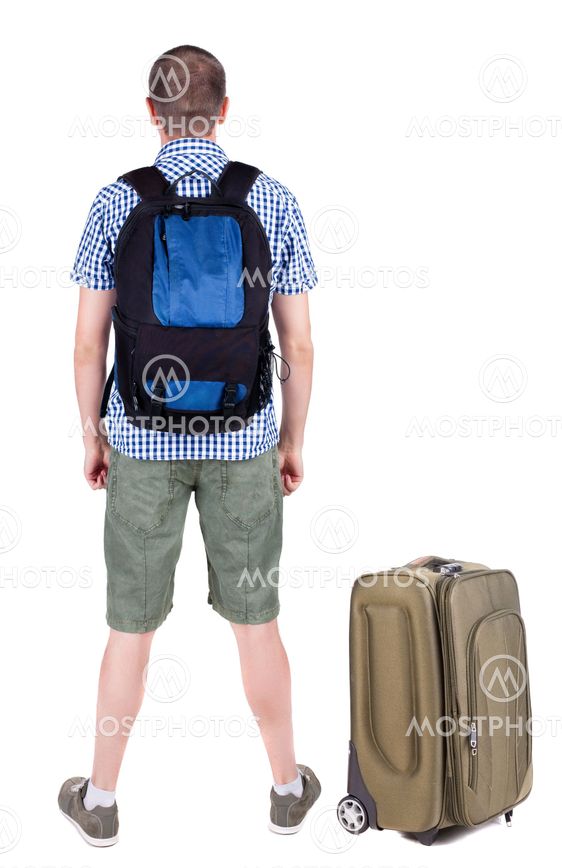 Back view of young man traveling with suitcas.