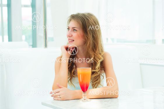 Portrait of a cute woman in a city cafe