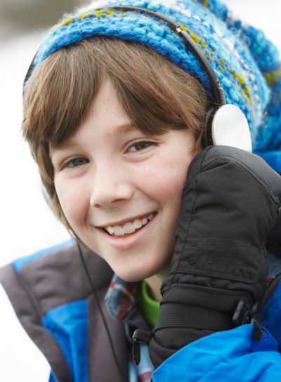 Boy Wearing Headphones And Listening To Music Wearing...