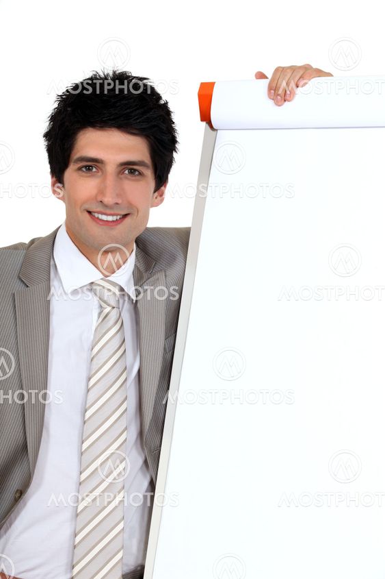 businessman posing next to a blank board