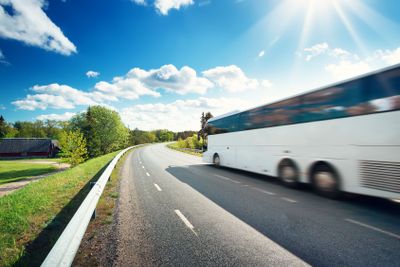 Bus on asphalt road in beautiful spring day