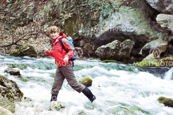 Girl crossing river