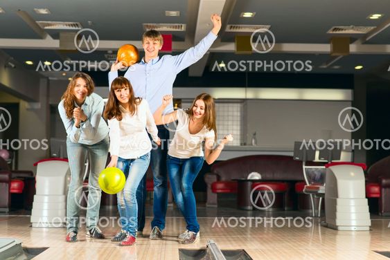 Group of young friends playing bowling