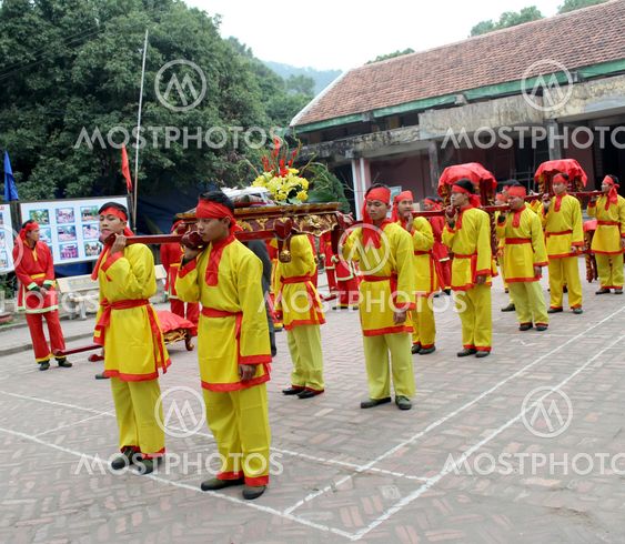 Group of people in traditional costume give gifts to the...