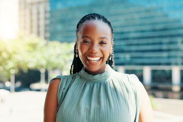 Business, portrait and smile of black woman in city for...