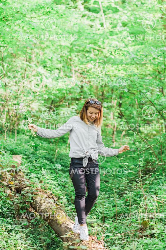 Young woman hiking through the forest