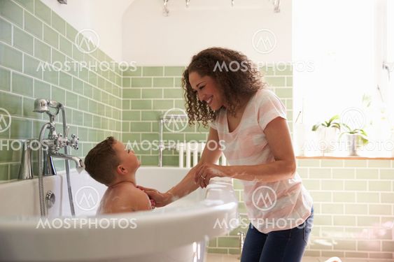 Mother And Son Having Fun At Bath Time Together