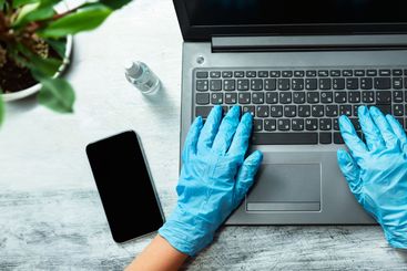 Woman in quarantine wearing protective gloves and working