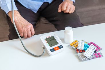 An old woman measures her blood pressure. Selective focus.